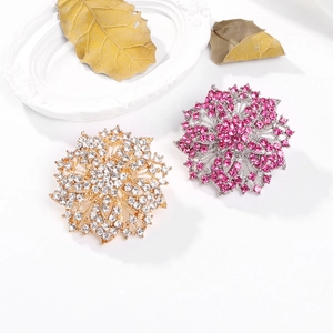 Detail of luxury crystal flower brooches with pink and white rhinestones in gold and silver