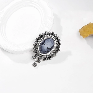 Vintage style cameo brooch with grey crystals, female portrait, and drop pendant decoration