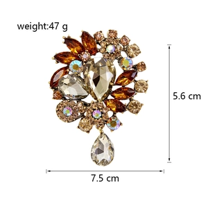 Detail view of large vintage flower brooch with crystals and amber champagne rhinestones