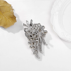 Macro view of silver alloy brooch back with secure safety pin and pearl inlay base