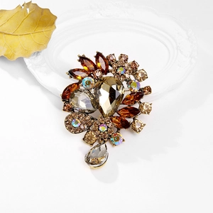 Macro detail of vintage floral brooch featuring smoke grey crystals and gold alloy base