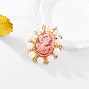 Macro shot of Victorian cameo brooch featuring pink lady portrait with pearls and crystals
