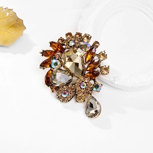 Vintage floral brooch with amber crystals and drop pendant on a white background