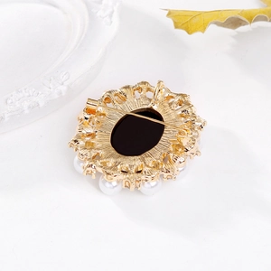 Detailed back view of a Victorian style brooch with a gold frame and pearl border