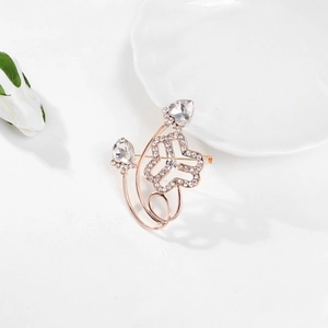 Elegant rose gold women federation brooch with white crystals on a white floral background