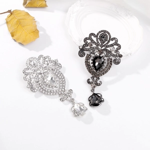 Baroque drop brooches with sparkling rhinestones in silver and gunblack finishes