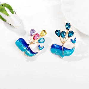 Cartoon blue whale enamel brooch with colorful balloon crystals on a white background
