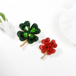 Elegant gold clover brooches with emerald green and ruby red crystal gemstones