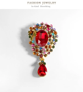 Vue détaillée de broche vintage avec cristal rouge goutte d'eau et strass multicolores
