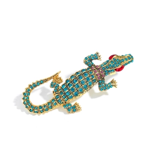 Crocodile shaped alloy brooch with sky blue rhinestones and gold-plated finish