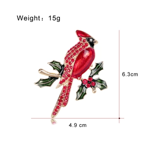 Red cardinal bird brooch on holly branch with red rhinestones and enamel finish