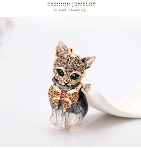 Detailed view of alloy cat brooch with sparkling rhinestones and green gem eyes