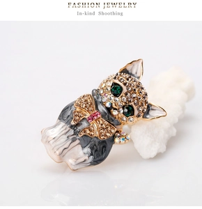 Detailed view of cat brooch with green gem eyes and sparkling rhinestone crystals