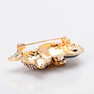 Back view of golden kitten brooch with gray rhinestones and secure pin fastening