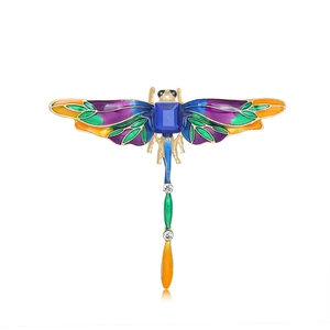 Vintage gold dragonfly brooch with colorful enamel wings and a deep blue gemstone
