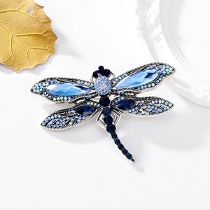 Vintage dragonfly brooch with sparkling blue rhinestones and silver alloy base