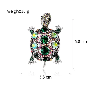 Vintage sea turtle brooch with green crystals and rainbow rhinestones on silver metal