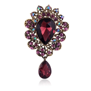 Vintage royal teardrop brooch with red pear-cut crystal and gold floral metal accents
