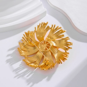 Vintage style matte gold floral brooch with sunburst tassels and textured metal finish
