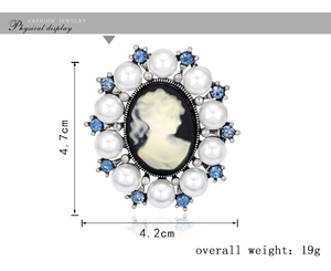 Detail of vintage cameo brooch showing 4.7cm height and faux pearl crystal frame
