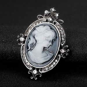Vintage Victorian cameo brooch with silver filigree frame and sparkling crystal accents