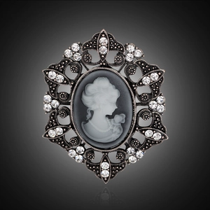 Macro shot of vintage lady cameo brooch with sparkling rhinestones and hollow metal frame
