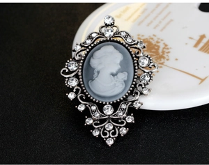 Macro detail of Victorian vintage relief brooch with sparkling rhinestones and silver frame