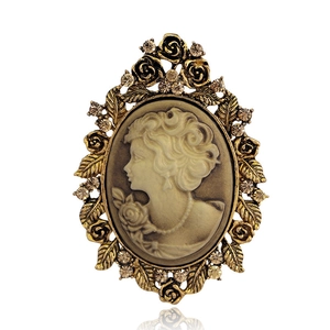 Vintage Victorian cameo brooch with golden floral frame and sparkling rhinestones