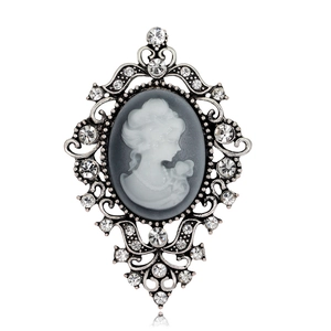 Vintage Victorian cameo brooch with silver petals and sparkling rhinestone accents