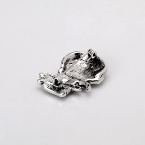 Silver vintage metal snowman brooch back view with classic pin closure and textured finish