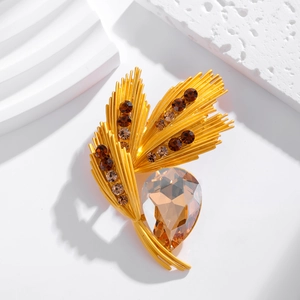 Luxury wheat ear brooch with gold rhinestones and teardrop gemstone on white decor