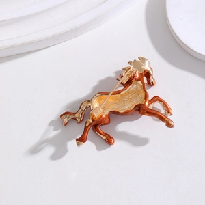 Back view of enamel horse brooch with secure safety pin clasp on white geometric tray
