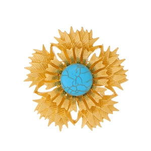Vintage gold floral brooch with textured petals and inlaid turquoise stone center