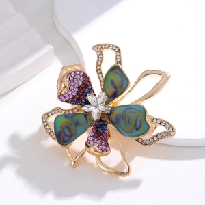 Elegant gold bow flower brooch with blue abalone shell enamel and purple crystals