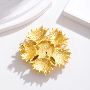 Golden flower vintage brooch back view showing secure pin closure and matte texture