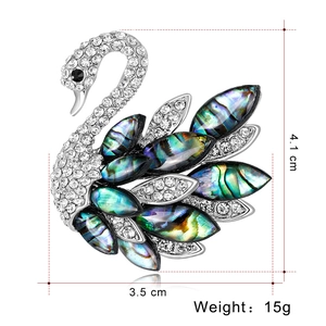 Elegant swan brooch with natural abalone shell feathers and sparkling crystal accents