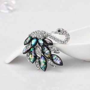 Elegant silver swan brooch with sparkling crystals and iridescent abalone shell