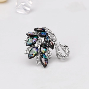 Elegant swan brooch with natural abalone shell wings and sparkling crystal rhinestones