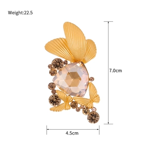 Golden butterfly brooch with champagne crystals and dimensions 7.0cm by 4.5cm
