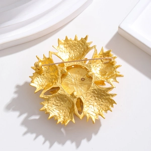 Vintage gold flower brooch with Czech rhinestones showing detailed back pin mechanism