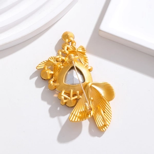 Elegant gold butterfly fish brooch with crystal stone and textured metal finish back view