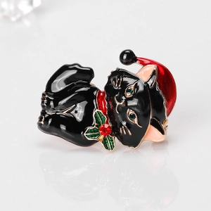 Cute Christmas black cat brooch with red hat and green rhinestone eyes on grey background