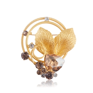 Vintage French gold leaf wreath brooch with crystal rhinestones on a white background