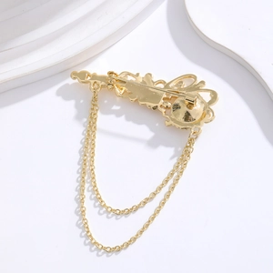Vintage gold alloy brooch pin with double layer chain tassels on minimalist background