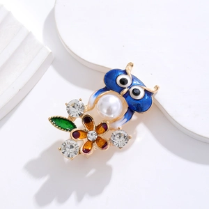 Exquisite owl brooch with blue enamel, white pearl abdomen and floral metal accents