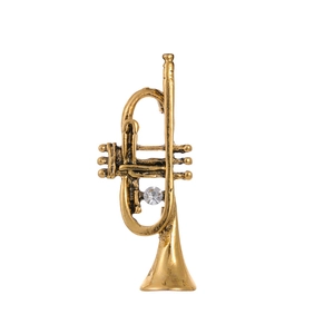 Vintage gold trumpet brooch with a central rhinestone detail on a minimalist background