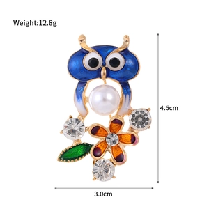 Chic blue owl brooch with pearl and floral enamel details on gold alloy base