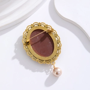 Vintage French relief brooch with ornate gold metal hollow frame and white pearl pendant