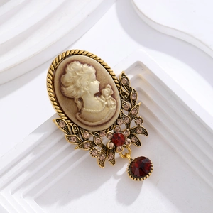 Vintage relief brooch with lady silhouette, gold frame, red gemstone and crystal accents
