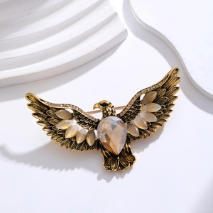 Vintage gold eagle brooch with brown gemstone and cat-eye stones for suits